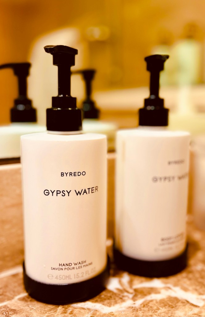 Close-up of Byredo Gypsy Water hand wash bottles on a marble countertop.
