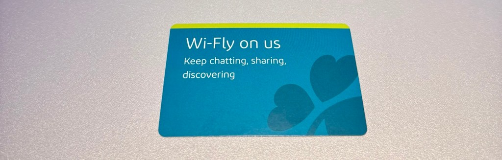Aer Lingus Wi-Fi access card with the text 'Wi-Fly on us' and the tagline 'Keep chatting, sharing, discovering'.