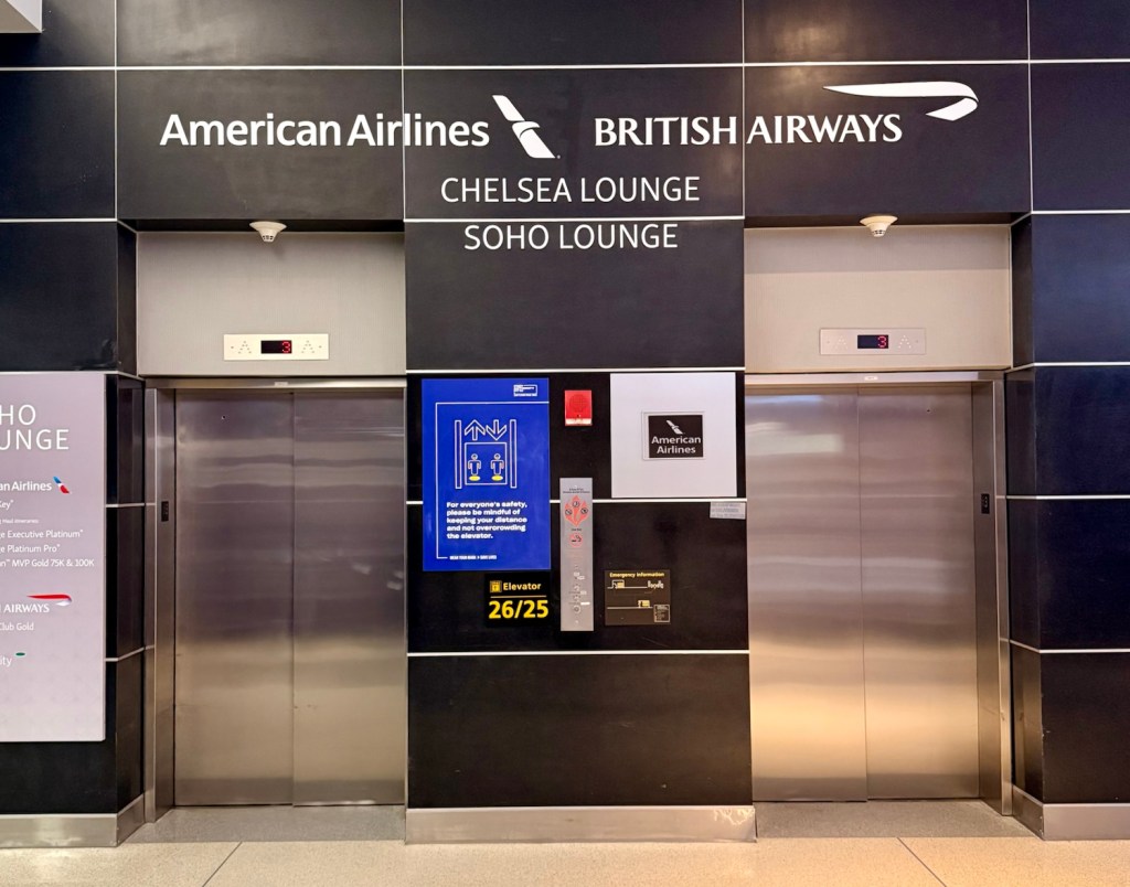 Entrance to the Chelsea and Soho Lounges at JFK Airport Terminal 8, featuring signage for American Airlines and British Airways, alongside elevator access.